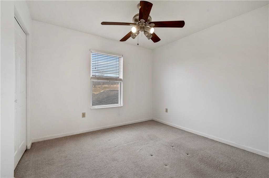 208 Commodore Drive McDonald, PA 15057 - Photo 24 of 36 an empty room with a ceiling fan and windows
