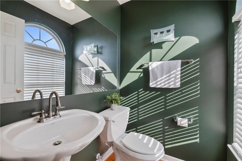 208 Commodore Drive McDonald, PA 15057 - Photo 8 of 36 a bathroom with a toilet sink and mirror