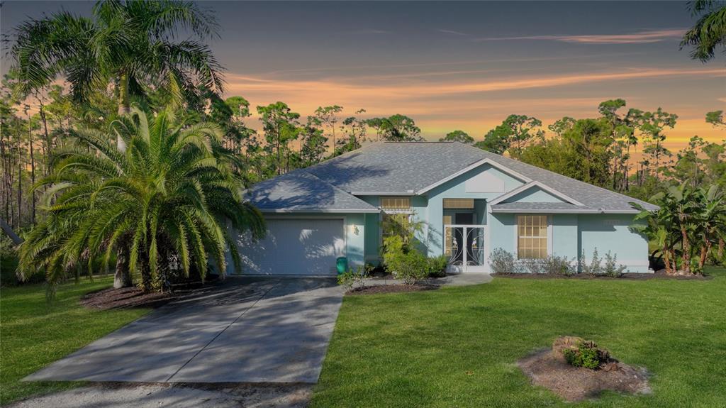 15265 Deer Pass Road Punta Gorda, FL 33955 - Photo 1 of 1 a front view of a house with a garden