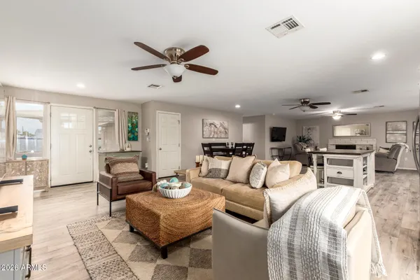 a living room with furniture and a view of kitchen