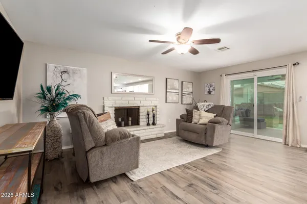 a living room with furniture a fireplace and a flat screen tv