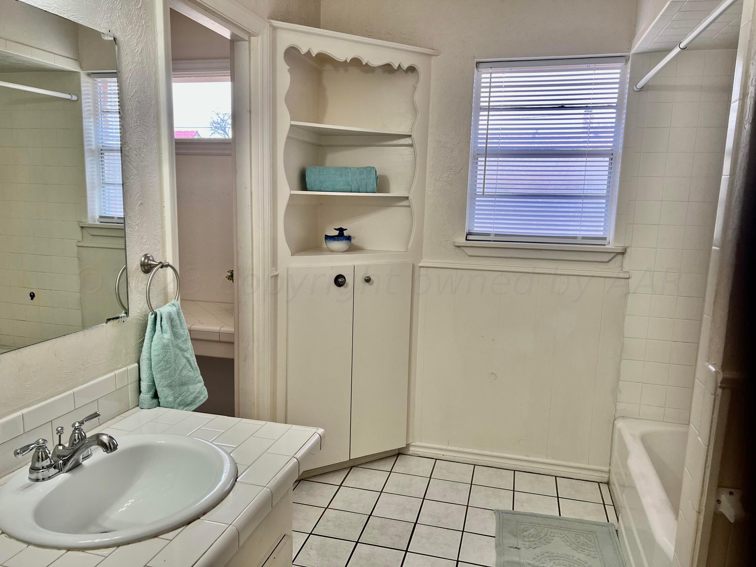 4600 Southwest 38th Avenue Amarillo, TX 79109 - Photo 11 of 19 a bathroom with a sink and a mirror
