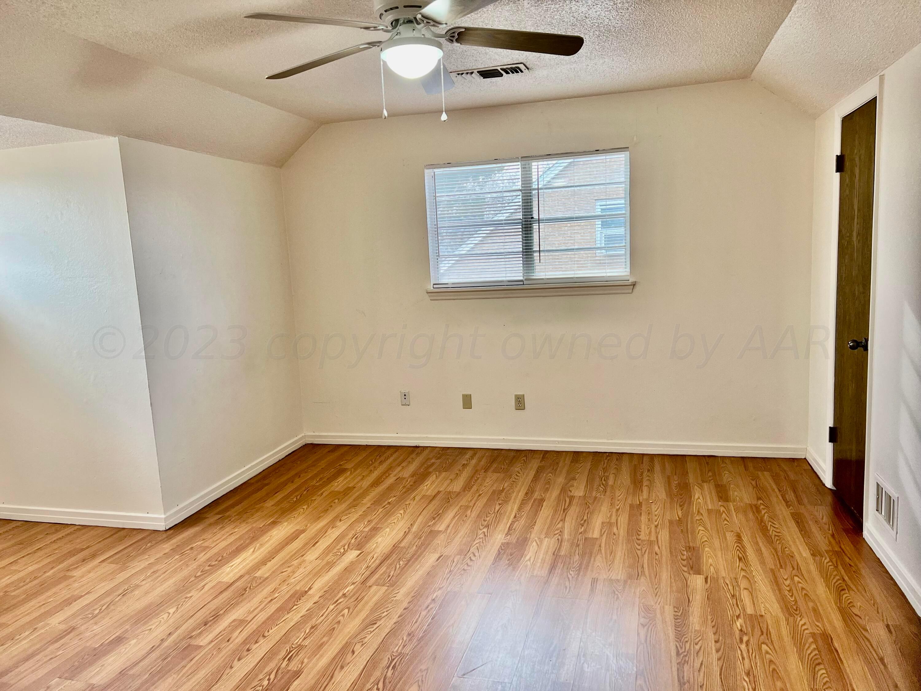 4600 Southwest 38th Avenue Amarillo, TX 79109 - Photo 15 of 19 an empty room with wooden floor and windows