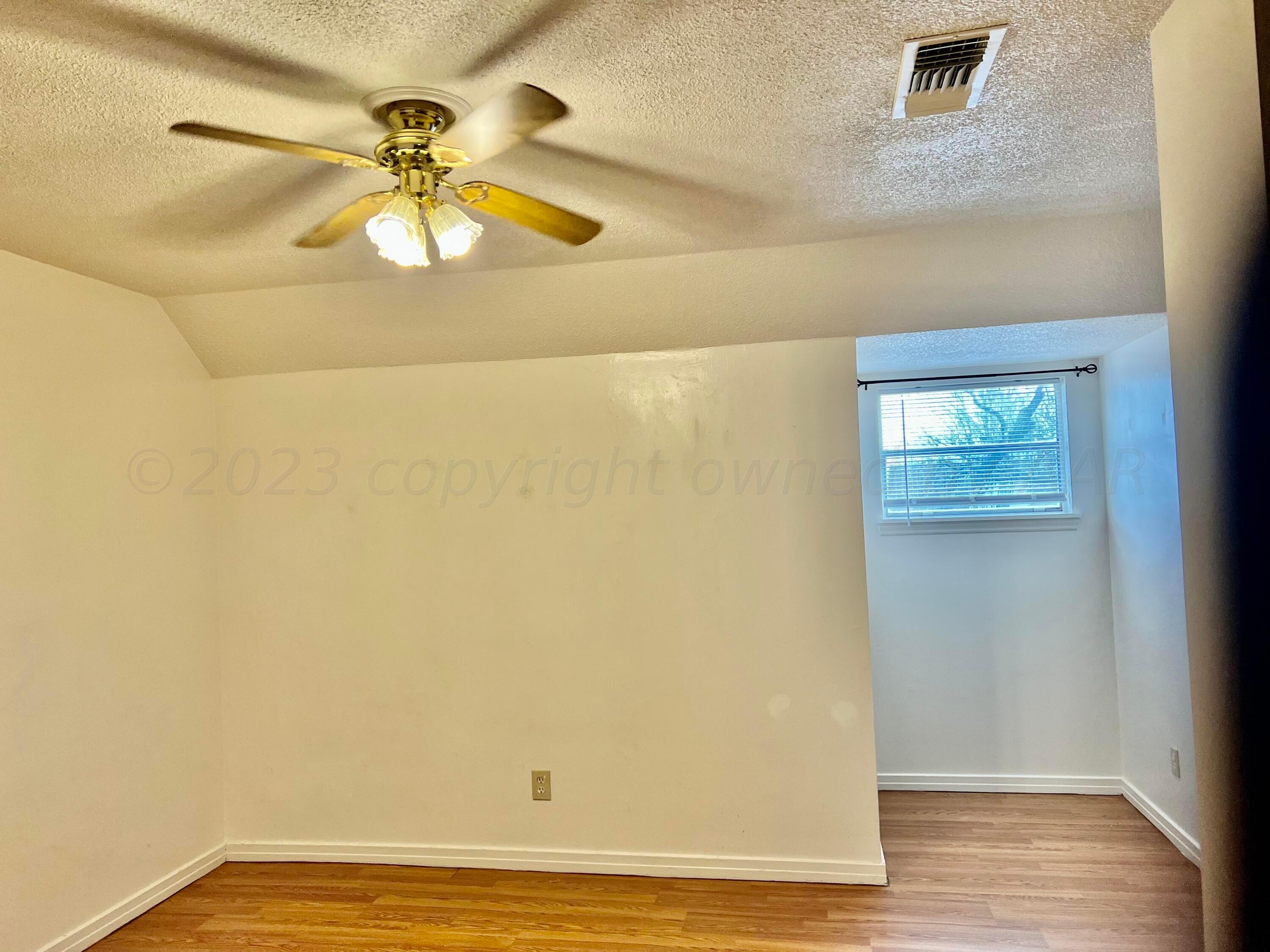 4600 Southwest 38th Avenue Amarillo, TX 79109 - Photo 17 of 19 a view of a big room with wooden floor and chandelier fan