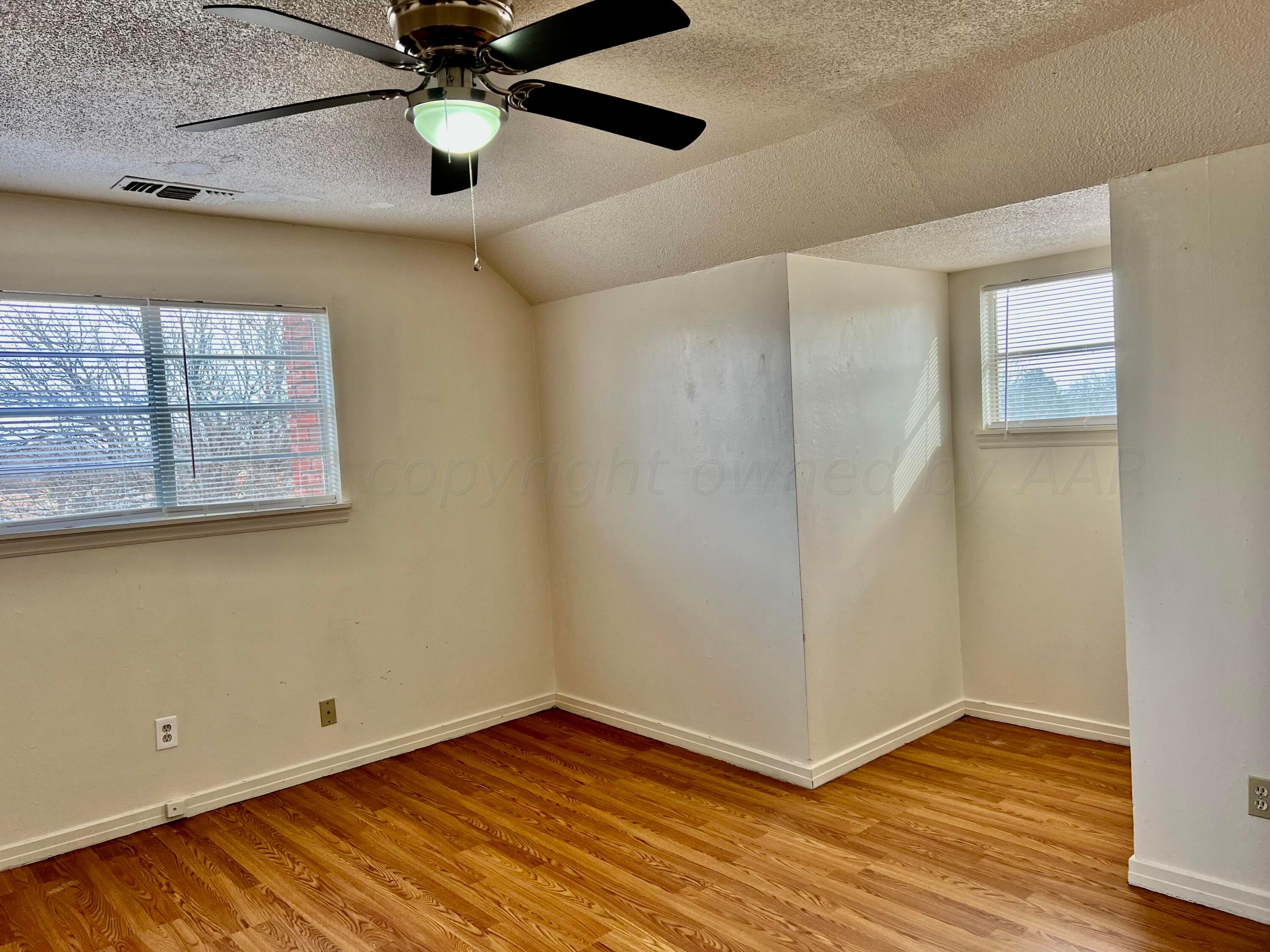 4600 Southwest 38th Avenue Amarillo, TX 79109 - Photo 18 of 19 a view of an empty room with wooden floor and a window