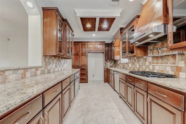 a kitchen with stainless steel appliances granite countertop a sink and a white cabinets