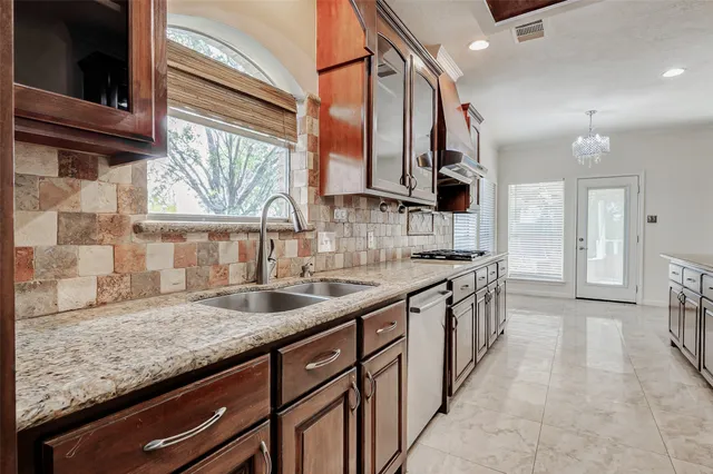 a spacious bedroom with a bed a couch and a window