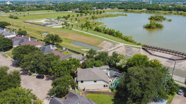 an aerial view of residential houses with outdoor space and lake view