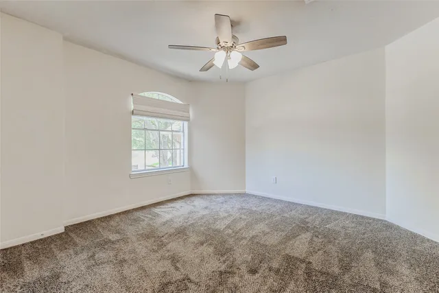 a spacious bedroom with a bed and a window