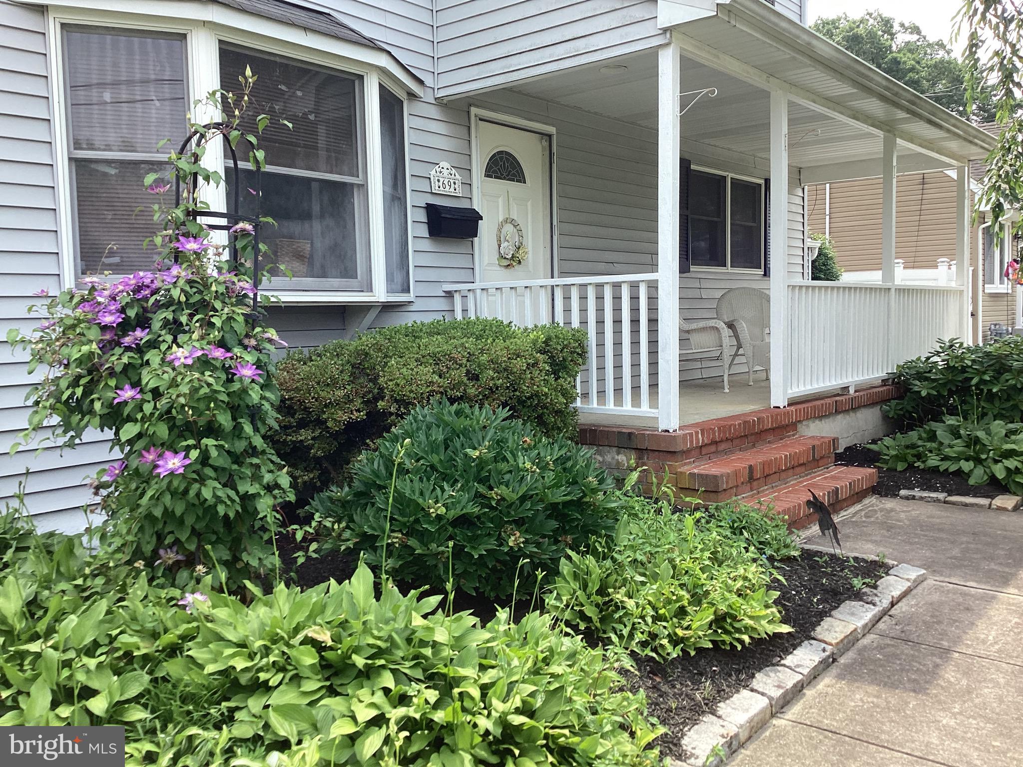 69 Wickom Avenue Hamilton, NJ 08690 - Photo 2 of 14 front view of a house with a garden