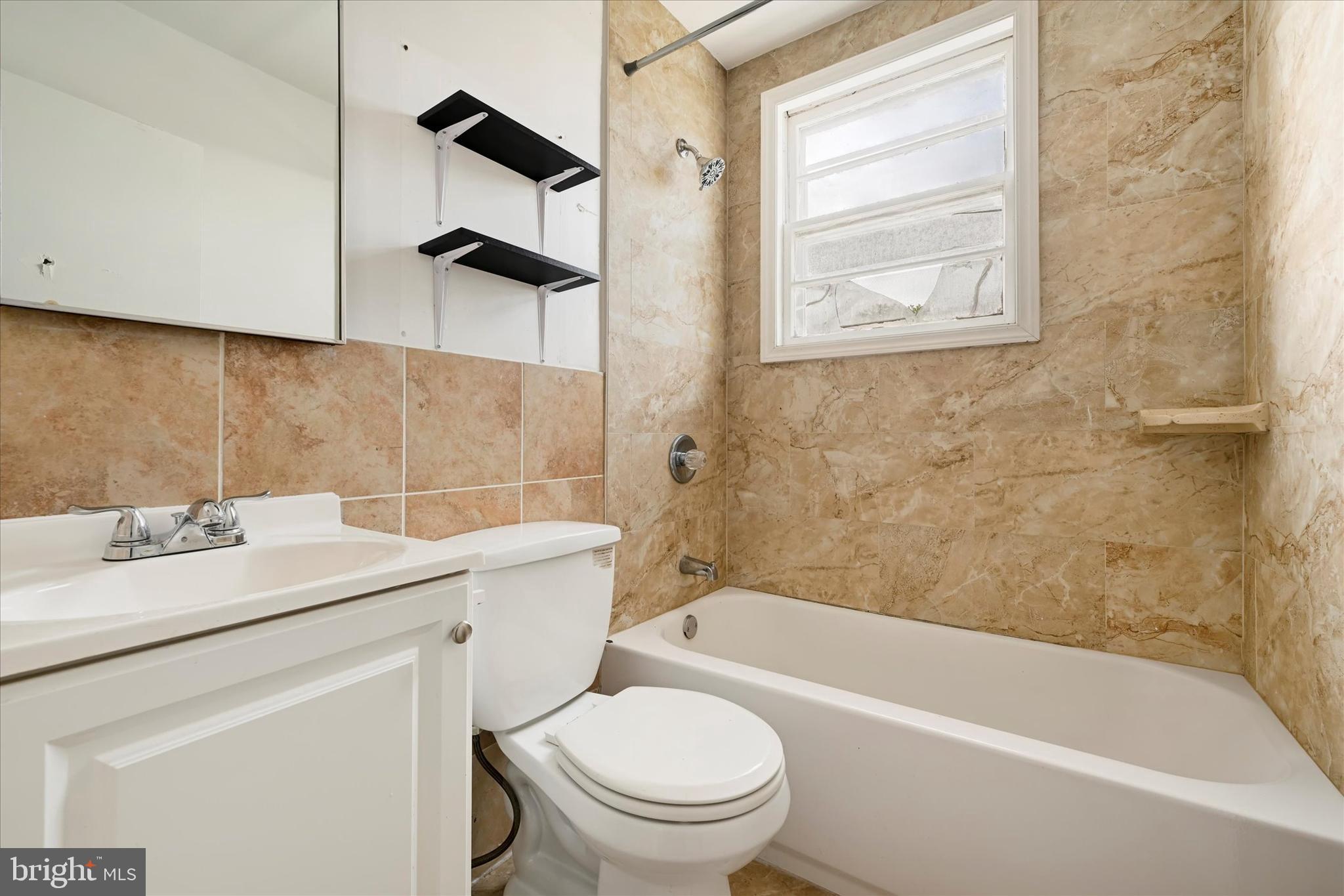 8059 Gray Haven Road Dundalk, MD 21222 - Photo 13 of 19 a bathroom with a sink a toilet and a bathtub