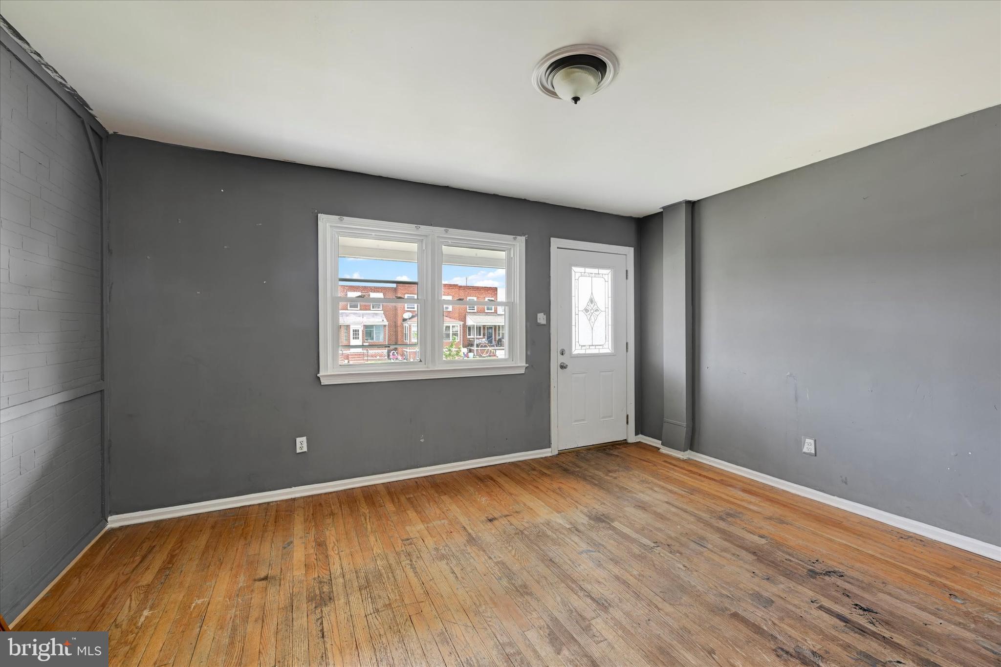 8059 Gray Haven Road Dundalk, MD 21222 - Photo 4 of 19 an empty room with wooden floor and windows