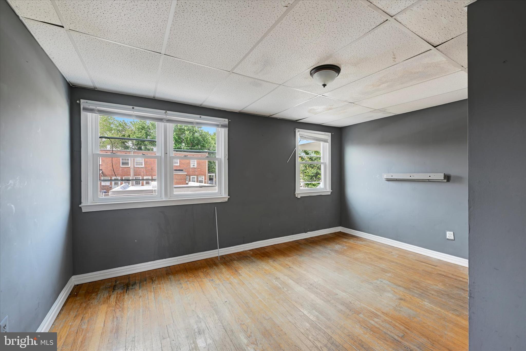 8059 Gray Haven Road Dundalk, MD 21222 - Photo 6 of 19 a view of empty room with wooden floor and fan