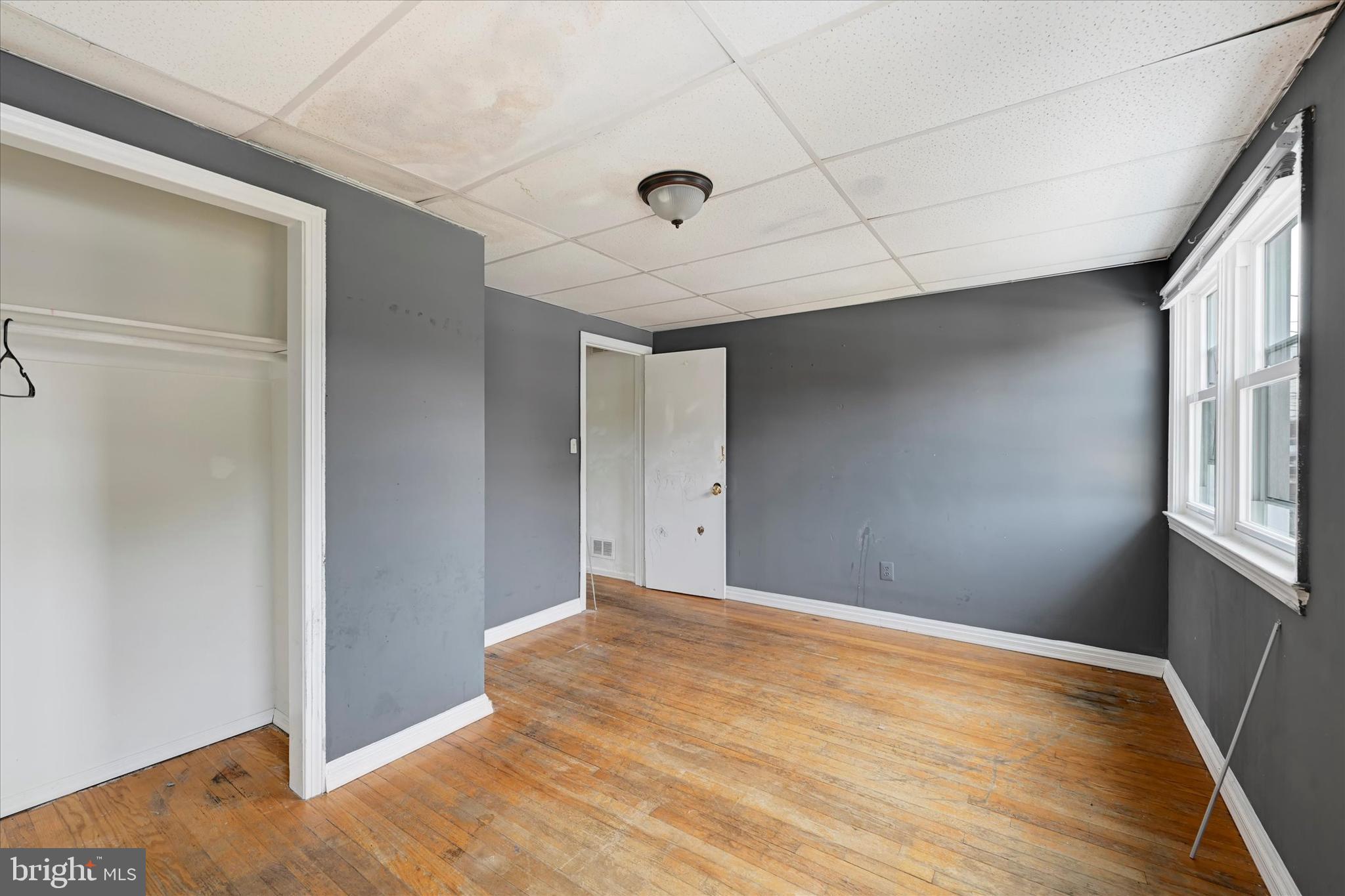 8059 Gray Haven Road Dundalk, MD 21222 - Photo 7 of 19 a view of empty room with wooden floor and fan