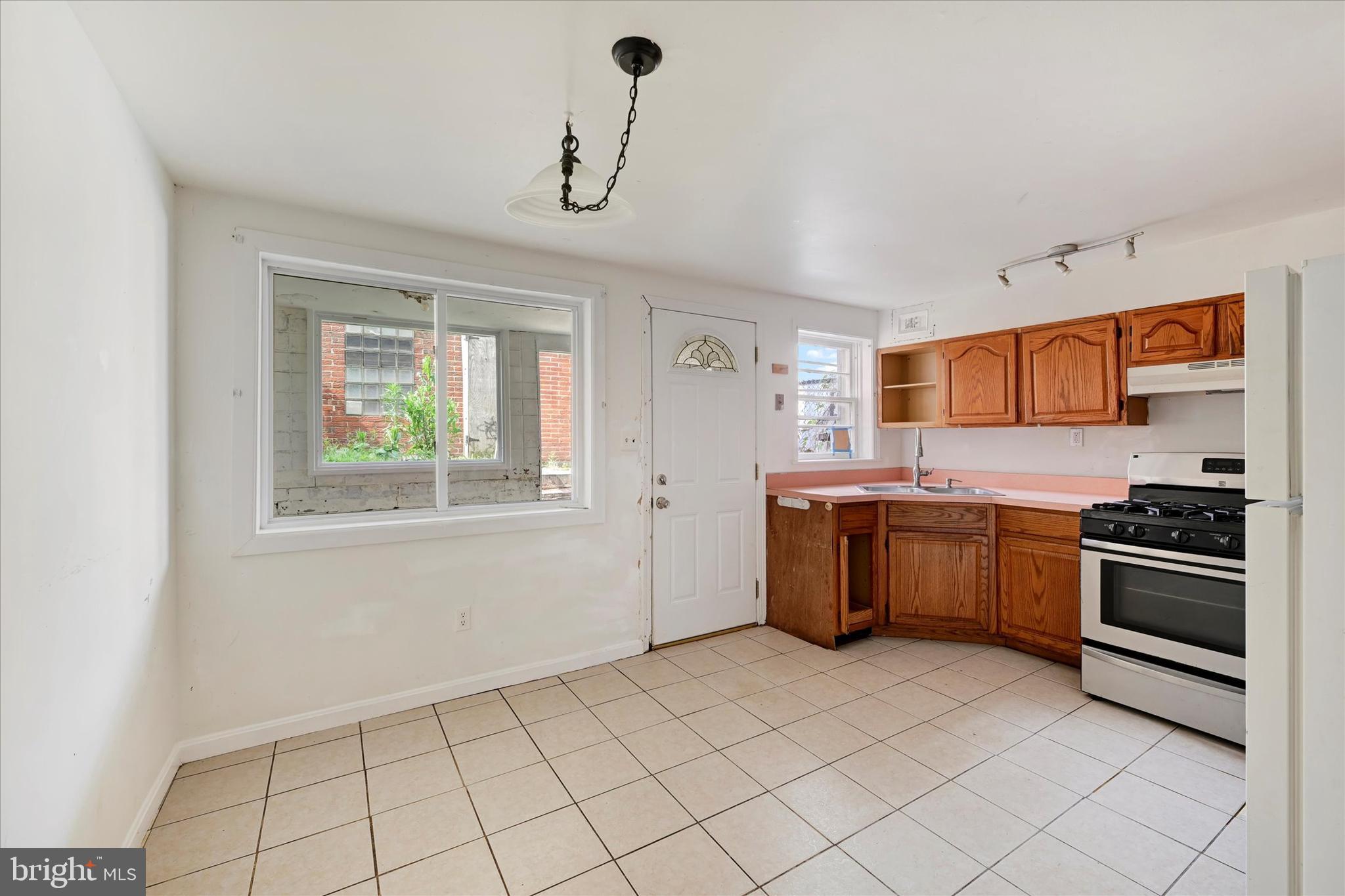 8059 Gray Haven Road Dundalk, MD 21222 - Photo 8 of 19 a kitchen with a stove a sink and a microwave