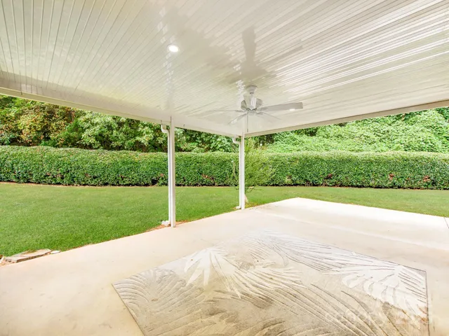 a view of a house with a yard and sitting area
