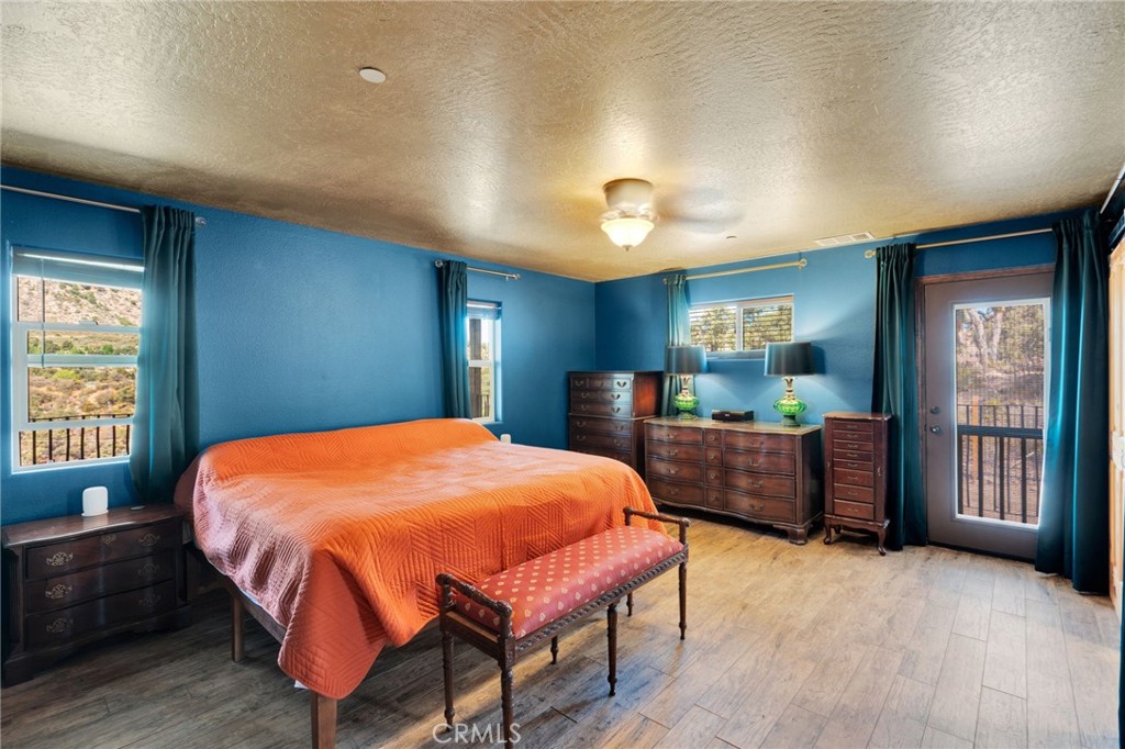 7635 Desert Front Road Wrightwood, CA 92397 - Photo 17 of 60 a bed room with a bed and a dresser