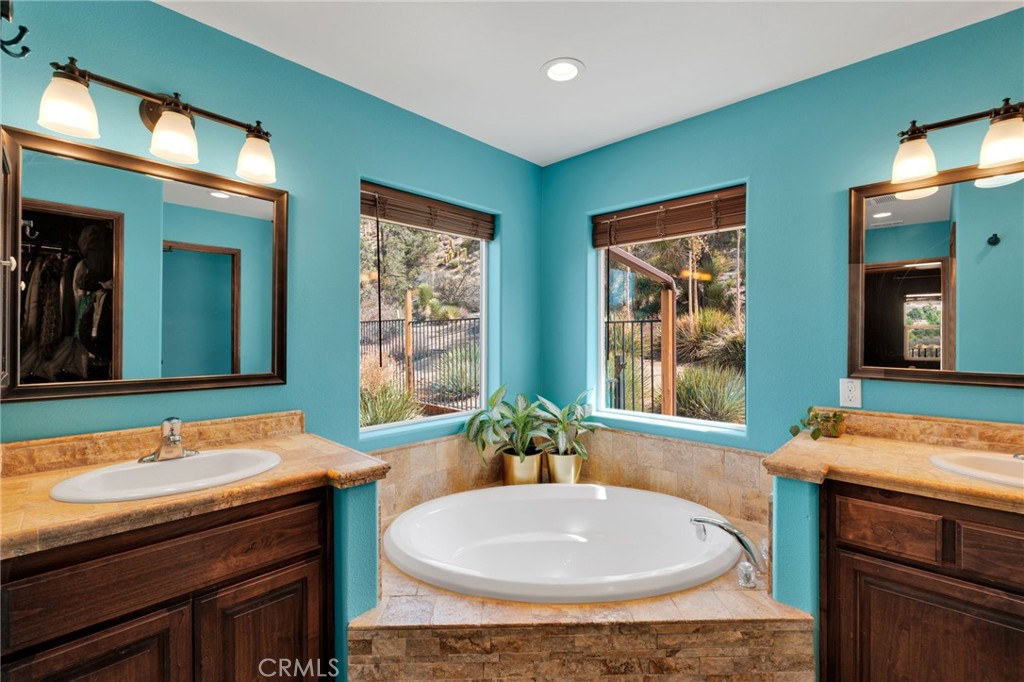 7635 Desert Front Road Wrightwood, CA 92397 - Photo 20 of 60 a bathroom with a sink a mirror and a bathtub