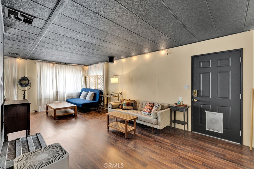 7635 Desert Front Road Wrightwood, CA 92397 - Photo 29 of 60 a living room with furniture and wooden floor
