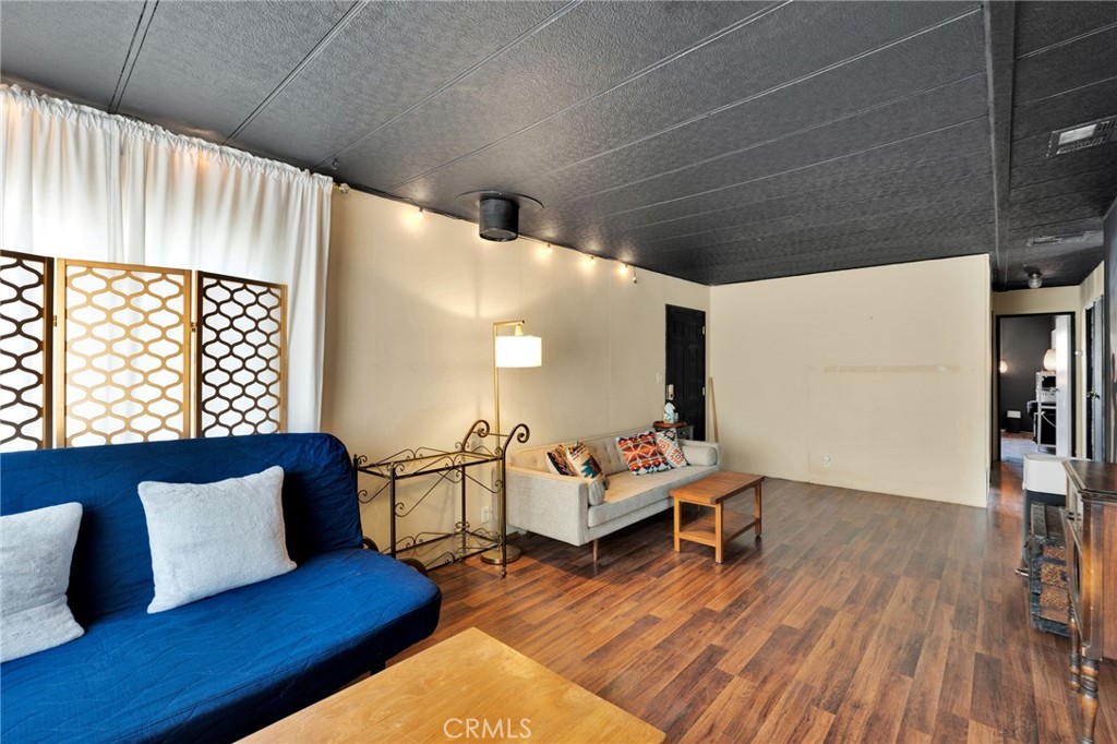 7635 Desert Front Road Wrightwood, CA 92397 - Photo 31 of 60 a living room with furniture and wooden floor