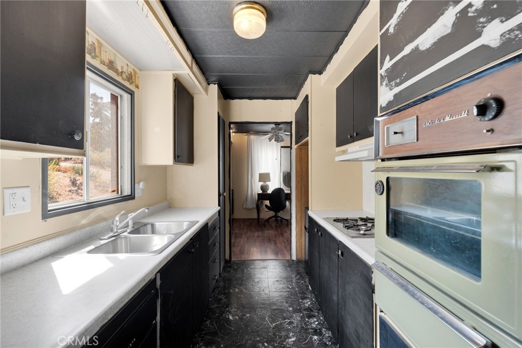 7635 Desert Front Road Wrightwood, CA 92397 - Photo 35 of 60 a kitchen with a sink appliances and cabinets