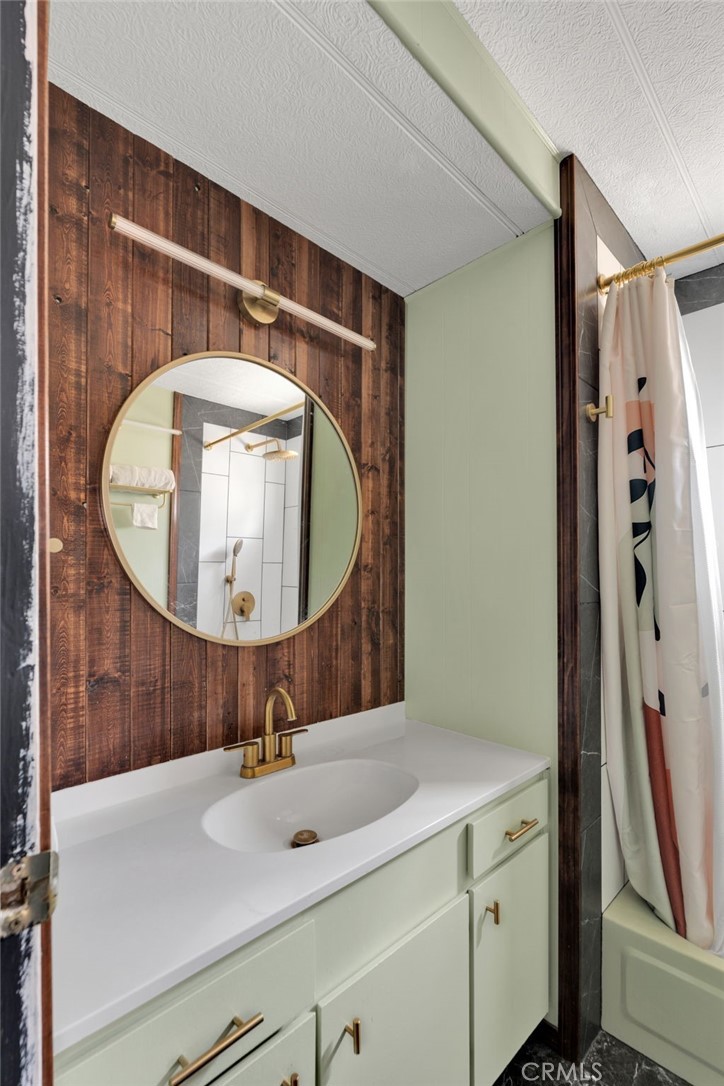7635 Desert Front Road Wrightwood, CA 92397 - Photo 39 of 60 a bathroom with a sink a mirror a vanity and shower