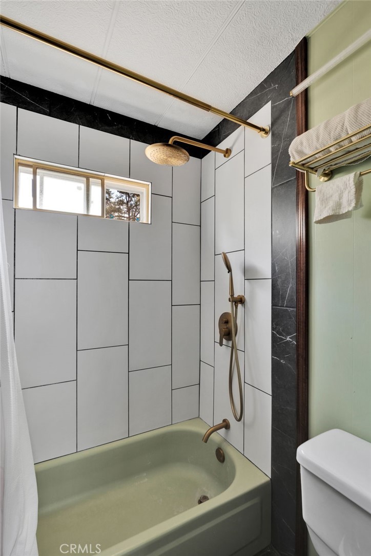 7635 Desert Front Road Wrightwood, CA 92397 - Photo 40 of 60 a bathroom with a shower and a toilet