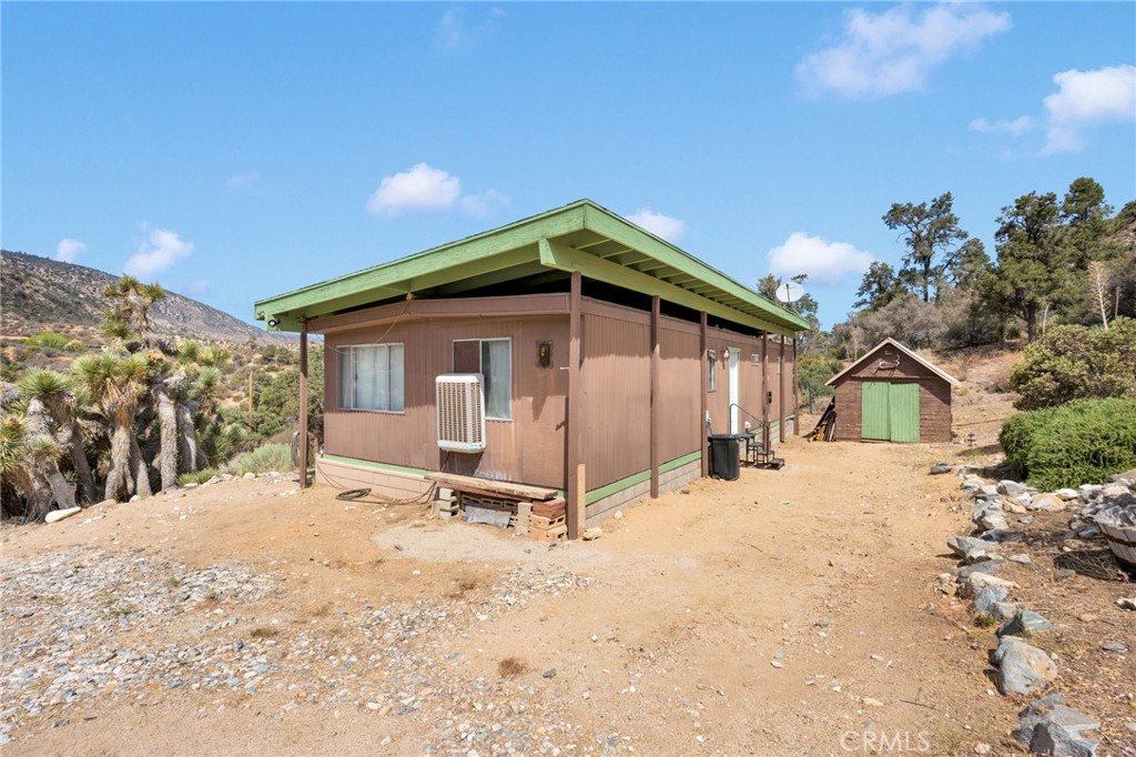 7635 Desert Front Road Wrightwood, CA 92397 - Photo 47 of 60 a view of a house with a yard