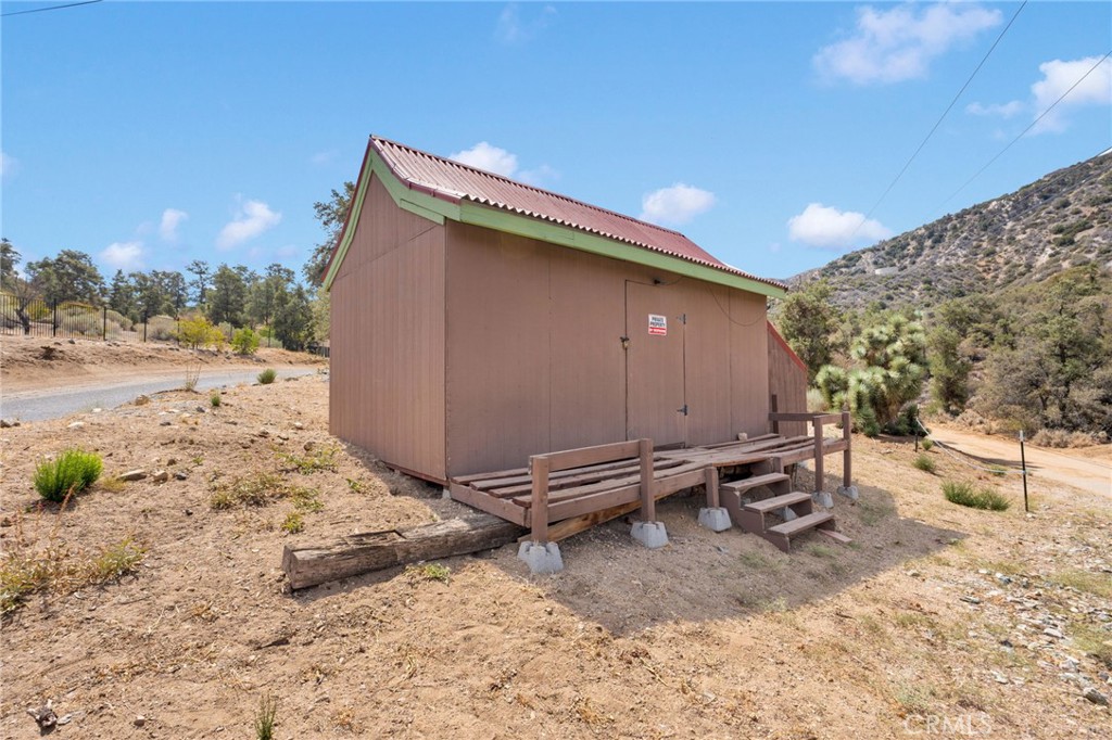 7635 Desert Front Road Wrightwood, CA 92397 - Photo 48 of 60 a backyard of a house with a yard and seating space