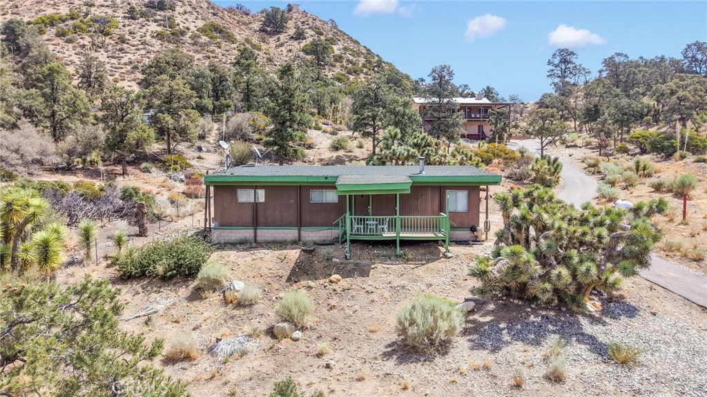 7635 Desert Front Road Wrightwood, CA 92397 - Photo 60 of 60 a view of a house with a yard and wooden fence
