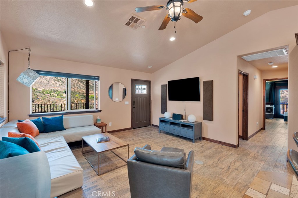 7635 Desert Front Road Wrightwood, CA 92397 - Photo 7 of 60 a living room with furniture and a flat screen tv