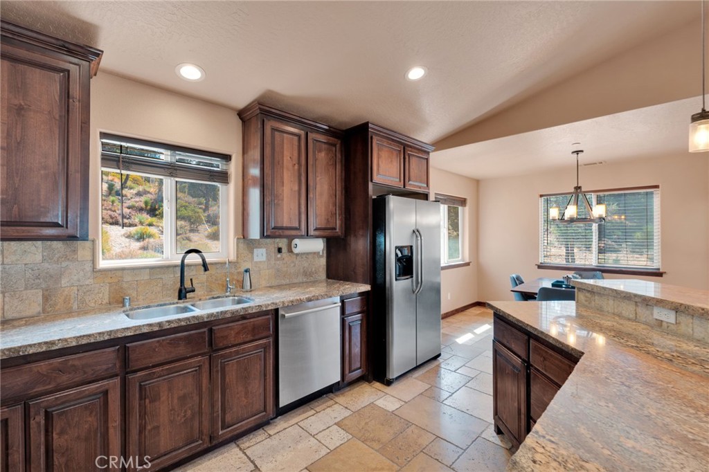 7635 Desert Front Road Wrightwood, CA 92397 - Photo 8 of 60 a open kitchen with stainless steel appliances granite countertop a sink stove and refrigerator