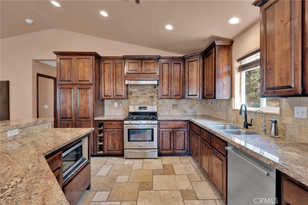 7635 Desert Front Road Wrightwood, CA 92397 - Photo 10 of 60 a kitchen with stainless steel appliances granite countertop a sink stove and refrigerator