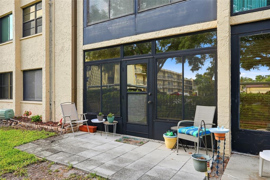12300 Vonn Road, Unit 7104 Largo, FL 33774 - Photo 19 of 41 a view of a patio with table and chairs and potted plants