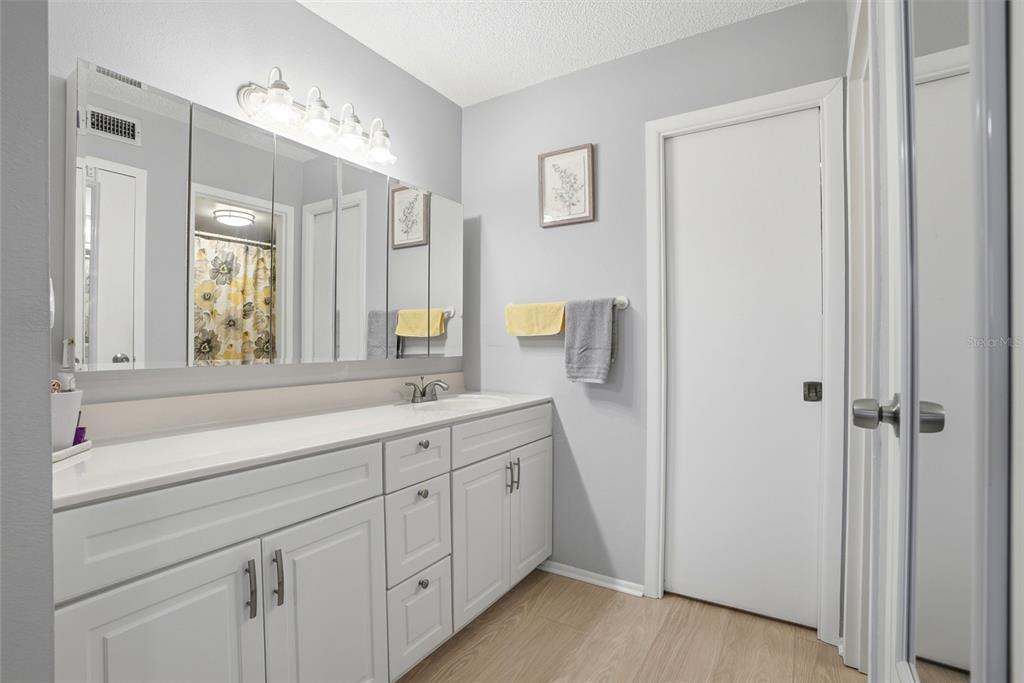 12300 Vonn Road, Unit 7104 Largo, FL 33774 - Photo 24 of 41 a bathroom with a double vanity sink and mirror with shower