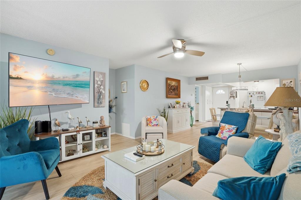 12300 Vonn Road, Unit 7104 Largo, FL 33774 - Photo 4 of 41 a living room with furniture and a flat screen tv