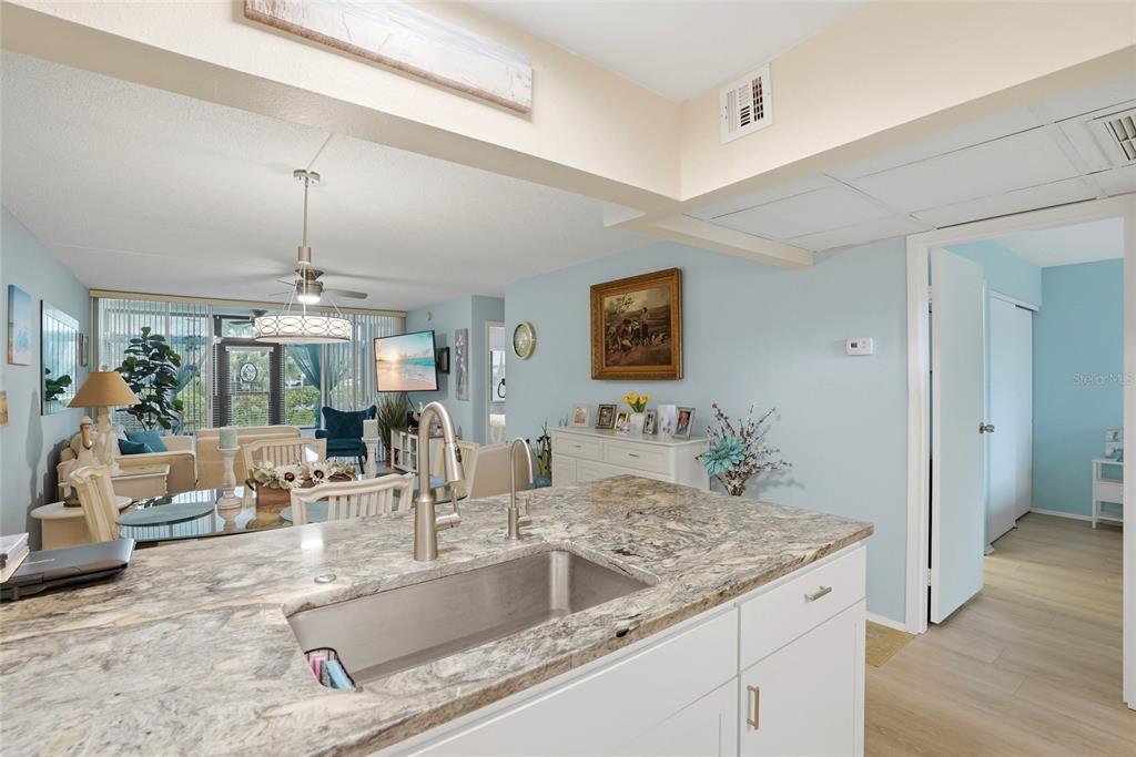 12300 Vonn Road, Unit 7104 Largo, FL 33774 - Photo 5 of 41 a kitchen with granite countertop a sink and a large mirror