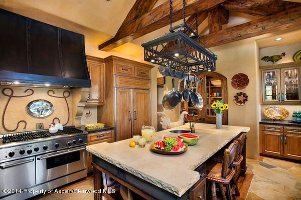 770 Pioneer Springs Ranch Road Aspen, CO 81611 - Photo 14 of 46 a view of a dining room with furniture and chandelier
