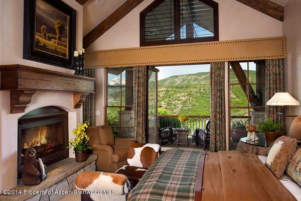 770 Pioneer Springs Ranch Road Aspen, CO 81611 - Photo 17 of 46 a living room with furniture a fireplace and a floor to ceiling window