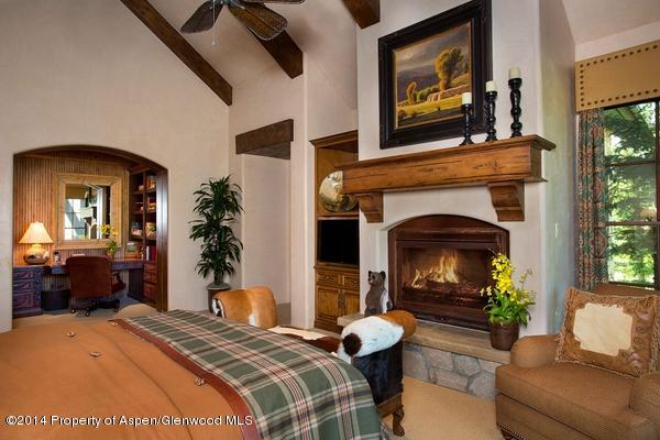 770 Pioneer Springs Ranch Road Aspen, CO 81611 - Photo 18 of 46 a bedroom with a balcony a bed and a fireplace