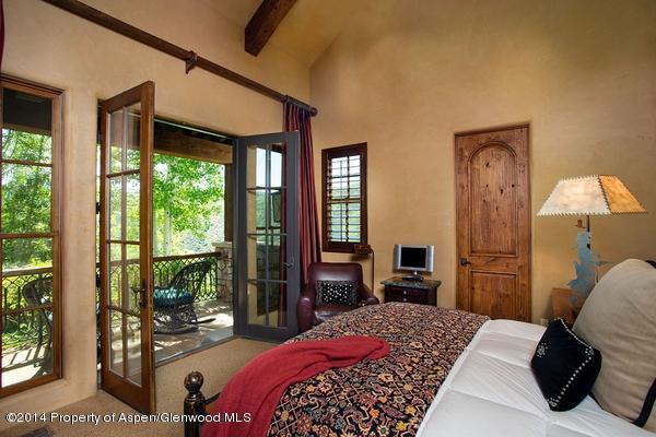 770 Pioneer Springs Ranch Road Aspen, CO 81611 - Photo 23 of 46 a bedroom with a bed and a flat tv screen next to a window