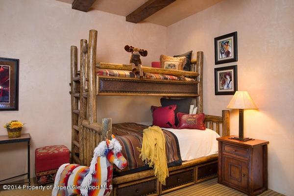770 Pioneer Springs Ranch Road Aspen, CO 81611 - Photo 25 of 46 a bedroom with a bed and wooden floor