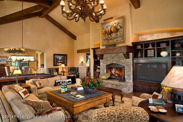 770 Pioneer Springs Ranch Road Aspen, CO 81611 - Photo 3 of 46 a living room with furniture a fireplace and a table