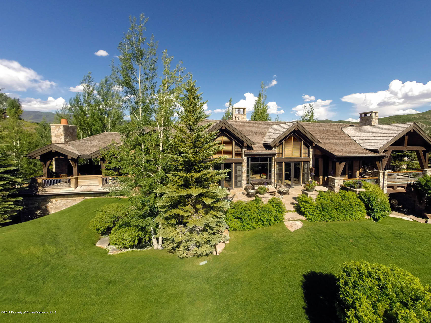 770 Pioneer Springs Ranch Road Aspen, CO 81611 - Photo 46 of 46 a front view of a house with a garden