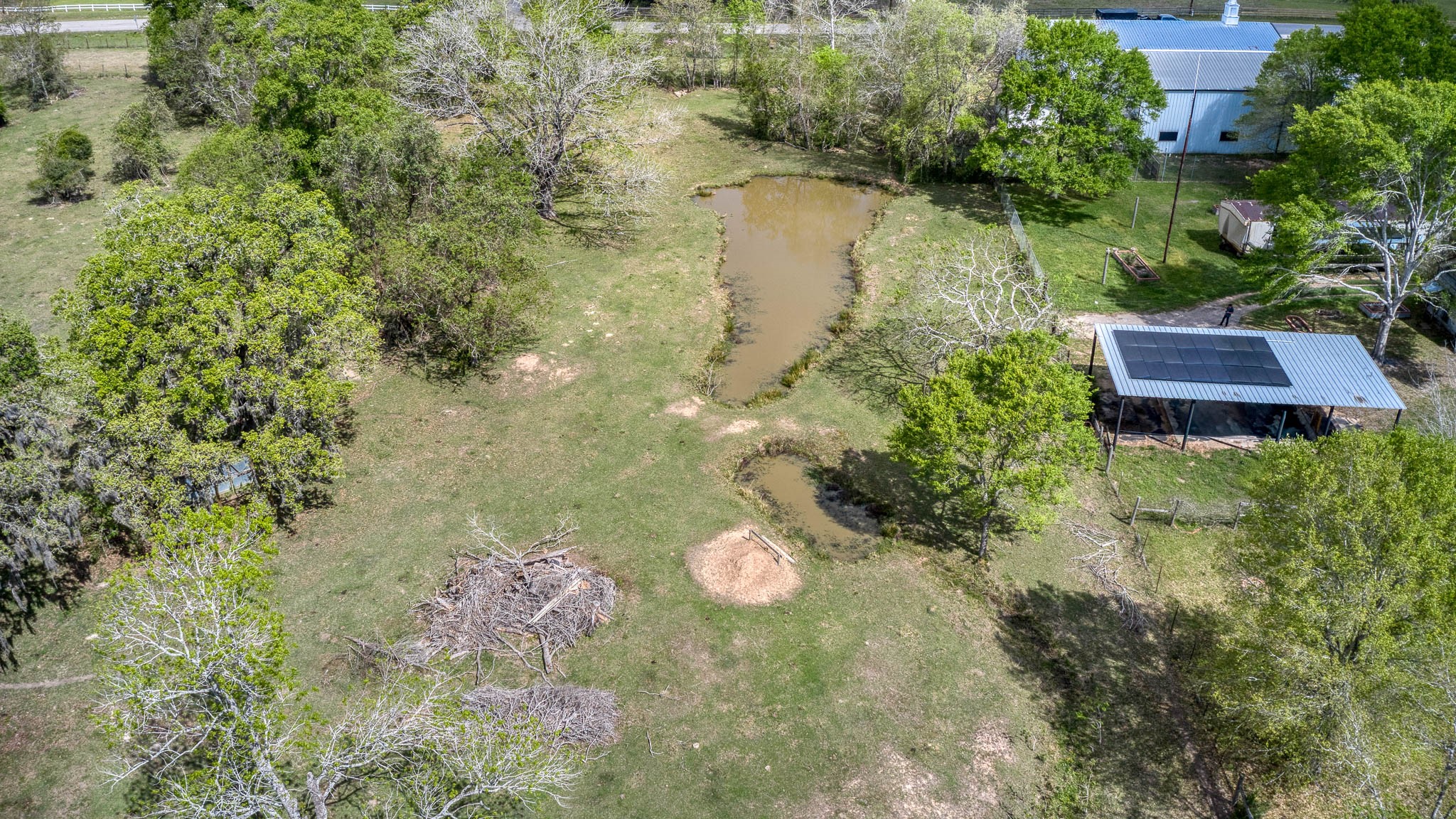 25945 Kickapoo Road Hockley, TX 77447 - Photo 28 of 35 Large pond & small pond next to 4 car carport with solar panels.