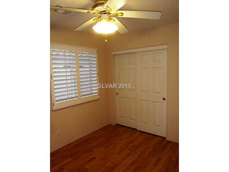 2114 Hidden Ranch Terrace Henderson, NV 89052 - Photo 16 of 27 Bedroom. 2nd bedroom with plantation shutters, ceiling fan and wood-like flooring.