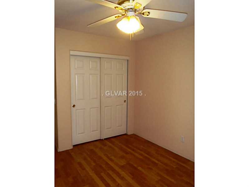 2114 Hidden Ranch Terrace Henderson, NV 89052 - Photo 18 of 27 Bedroom. 3rd bedroom with plantation shutters, ceiling fan and wood-like flooring.
