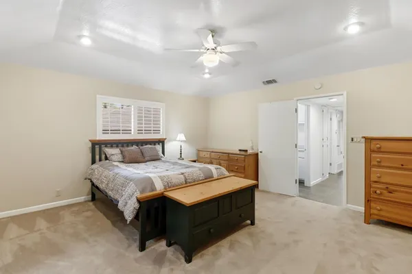 a bedroom with a large bed and a flat screen tv