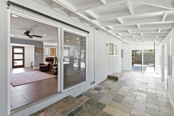 a view of a house with backyard and sitting area