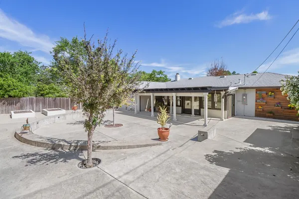 a view of a house with a patio and a palm tree